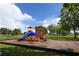 Colorful community playground with slides, climbing structures and green space at 16271 Branco Dr, Punta Gorda, FL 33955
