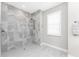 Modern bathroom with a spacious walk-in shower featuring elegant marble tiling and a sleek showerhead at 16271 Branco Dr, Punta Gorda, FL 33955