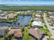 Picturesque aerial shot of waterfront homes with docks along a tranquil canal leading to expansive natural waterways at 1631 Casey Key Dr, Punta Gorda, FL 33950