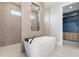 Modern bathroom features a freestanding tub, walk-in shower, and access to the walk-in closet at 1631 Casey Key Dr, Punta Gorda, FL 33950