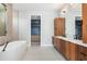 Modern bathroom with dual vanities, soaking tub, and walk-in closet at 1631 Casey Key Dr, Punta Gorda, FL 33950