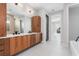 Beautiful bathroom features dual sinks, wood cabinets, and an expansive countertop at 1631 Casey Key Dr, Punta Gorda, FL 33950