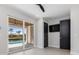 Well-lit bedroom with sliding glass doors, closet, and a mounted flat screen television at 1631 Casey Key Dr, Punta Gorda, FL 33950