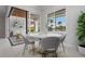 Cozy dining area features a round table with views of the outdoor patio and lush landscaping at 1631 Casey Key Dr, Punta Gorda, FL 33950