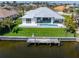 Modern waterfront home featuring a private pool, boat dock, and well-manicured lawn, perfect for outdoor living at 1631 Casey Key Dr, Punta Gorda, FL 33950
