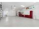 Spacious garage with epoxy flooring, ample storage cabinets, and overhead shelving at 1631 Casey Key Dr, Punta Gorda, FL 33950