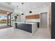 Modern kitchen featuring a waterfall island, sleek cabinetry, and an open layout to the backyard at 1631 Casey Key Dr, Punta Gorda, FL 33950