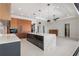 Modern kitchen with a spacious island, sleek cabinetry, stainless steel appliances, and designer light fixtures at 1631 Casey Key Dr, Punta Gorda, FL 33950