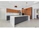 Modern kitchen with an island, wood cabinets, stainless steel appliances, and stone countertops at 1631 Casey Key Dr, Punta Gorda, FL 33950