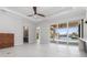 Spacious living room with tile floors, modern decor, and a sliding door that leads to the outdoor living space at 1631 Casey Key Dr, Punta Gorda, FL 33950