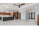 Spacious living area featuring modern lighting, an island kitchen, and sleek tile flooring at 1631 Casey Key Dr, Punta Gorda, FL 33950