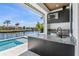 Outdoor kitchen features stainless steel appliances, granite counters, a grill, TV, and waterfront views at 1631 Casey Key Dr, Punta Gorda, FL 33950
