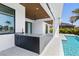 Outdoor kitchen features granite counters and bar seating adjacent to the covered patio and beautiful pool at 1631 Casey Key Dr, Punta Gorda, FL 33950