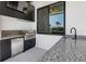 Outdoor kitchen features stainless steel appliances, granite counters, a grill, and waterfront views at 1631 Casey Key Dr, Punta Gorda, FL 33950