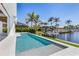 Inviting private pool and patio overlooking the waterfront with boat dock, perfect for outdoor relaxation at 1631 Casey Key Dr, Punta Gorda, FL 33950