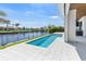 Backyard pool overlooking boat dock on a canal with grass and outdoor kitchen at 1631 Casey Key Dr, Punta Gorda, FL 33950