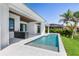 Inviting backyard pool with an outdoor kitchen, patio, and lush landscaping at 1631 Casey Key Dr, Punta Gorda, FL 33950