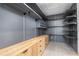 Organized walk-in closet with custom shelving and a spacious layout for optimal storage solutions at 1631 Casey Key Dr, Punta Gorda, FL 33950
