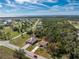 Aerial view of a neighborhood house featuring a long driveway and a screened-in pool at 16571 Cape Horn Blvd, Punta Gorda, FL 33955