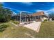 The backyard features a brick trimmed patio outside of a screen enclosed pool and landscaping at 16571 Cape Horn Blvd, Punta Gorda, FL 33955