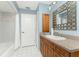 Bathroom featuring granite countertop, decorative mirror, storage and combination tub and shower at 16571 Cape Horn Blvd, Punta Gorda, FL 33955