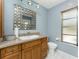Bathroom featuring granite countertop, stylish mirror, and a window at 16571 Cape Horn Blvd, Punta Gorda, FL 33955