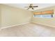 Bedroom with ceiling fan, and neutral colored walls and tile floor at 16571 Cape Horn Blvd, Punta Gorda, FL 33955