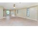 Expansive bedroom featuring tile floors, neutral walls, a ceiling fan, and large windows for natural light at 16571 Cape Horn Blvd, Punta Gorda, FL 33955