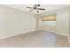 Standard bedroom with tile floors, neutral walls, a ceiling fan, and a window offering natural light at 16571 Cape Horn Blvd, Punta Gorda, FL 33955