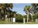 Community area with lush landscaping, palm trees, and waterfront access for residents to enjoy at 16571 Cape Horn Blvd, Punta Gorda, FL 33955