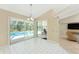 Bright dining area featuring tiled floors and sliding doors to screened-in pool at 16571 Cape Horn Blvd, Punta Gorda, FL 33955