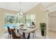 Bright dining room with a modern table setting, overlooking a screened-in pool area at 16571 Cape Horn Blvd, Punta Gorda, FL 33955