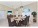 Cozy dining room with a large window providing ample natural light and a wooden table with six chairs at 16571 Cape Horn Blvd, Punta Gorda, FL 33955