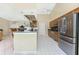 Spacious kitchen featuring stainless steel appliances, wooden cabinetry, and tile flooring in an open layout at 16571 Cape Horn Blvd, Punta Gorda, FL 33955