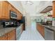 Bright kitchen with stainless steel appliances, granite countertops, wood cabinets, and a view of the pool at 16571 Cape Horn Blvd, Punta Gorda, FL 33955