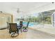 The outdoor patio features a dining set overlooking the pool and hot tub at 16571 Cape Horn Blvd, Punta Gorda, FL 33955