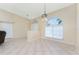 Spacious living room featuring neutral paint, tile floors, arched windows, and modern lighting fixtures at 16571 Cape Horn Blvd, Punta Gorda, FL 33955