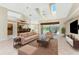 Spacious living room with modern furnishings, high ceilings, and a view of the outdoor area at 16571 Cape Horn Blvd, Punta Gorda, FL 33955
