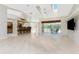 Open living space with high ceilings, tile floors, kitchen bar, and views of the outdoor lanai at 16571 Cape Horn Blvd, Punta Gorda, FL 33955