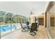 Relaxing screened pool with outdoor dining area and ceiling fan, perfect for entertaining and enjoying sunny days at 16571 Cape Horn Blvd, Punta Gorda, FL 33955