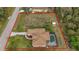 Aerial view of property showcasing the house, screened pool, yard and lot lines at 17327 Wintergarden Ave, Port Charlotte, FL 33948