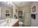 Well-maintained bathroom featuring vanity sink, glass shower doors, and decorative towel racks at 17327 Wintergarden Ave, Port Charlotte, FL 33948