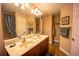 Bathroom featuring dual sinks, framed mirror, decorative fixtures, and a separate shower area at 17327 Wintergarden Ave, Port Charlotte, FL 33948
