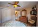 Cozy bedroom with closet, dresser, wall-mounted television and comfortable chair at 17327 Wintergarden Ave, Port Charlotte, FL 33948