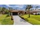 Charming single-story home with a well-manicured lawn and beautiful landscaping at 17327 Wintergarden Ave, Port Charlotte, FL 33948