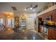 Modern kitchen featuring granite countertops, stainless steel appliances, and decorative ceiling fan at 17327 Wintergarden Ave, Port Charlotte, FL 33948