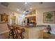 Well-lit kitchen with breakfast bar, offering cherry cabinets, and sleek stainless appliances at 17327 Wintergarden Ave, Port Charlotte, FL 33948