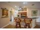 Inviting kitchen with breakfast bar, cherry cabinets, stainless appliances, and overhead decor at 17327 Wintergarden Ave, Port Charlotte, FL 33948