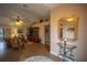 Inviting living room with tile floors, ceiling fan, and an elegant console table with a mirror at 17327 Wintergarden Ave, Port Charlotte, FL 33948