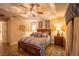 Comfortable main bedroom boasts stylish ceiling fan, tray ceiling, attractive decor, and warm lighting at 17327 Wintergarden Ave, Port Charlotte, FL 33948